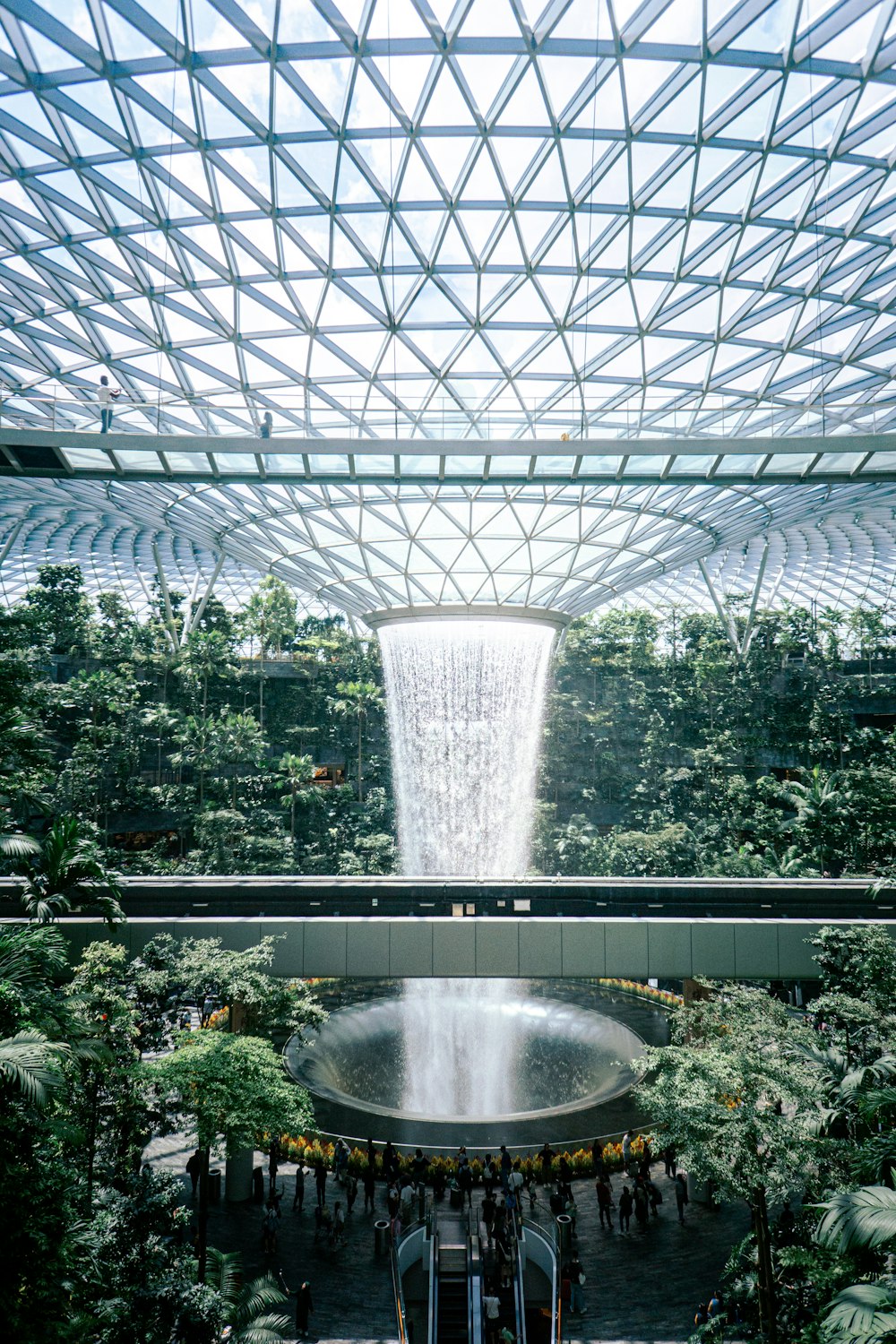 the inside of a building with a waterfall in the middle