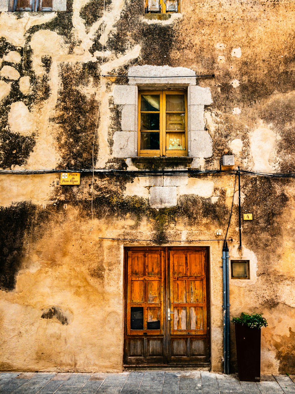 an old building with a wooden door and window