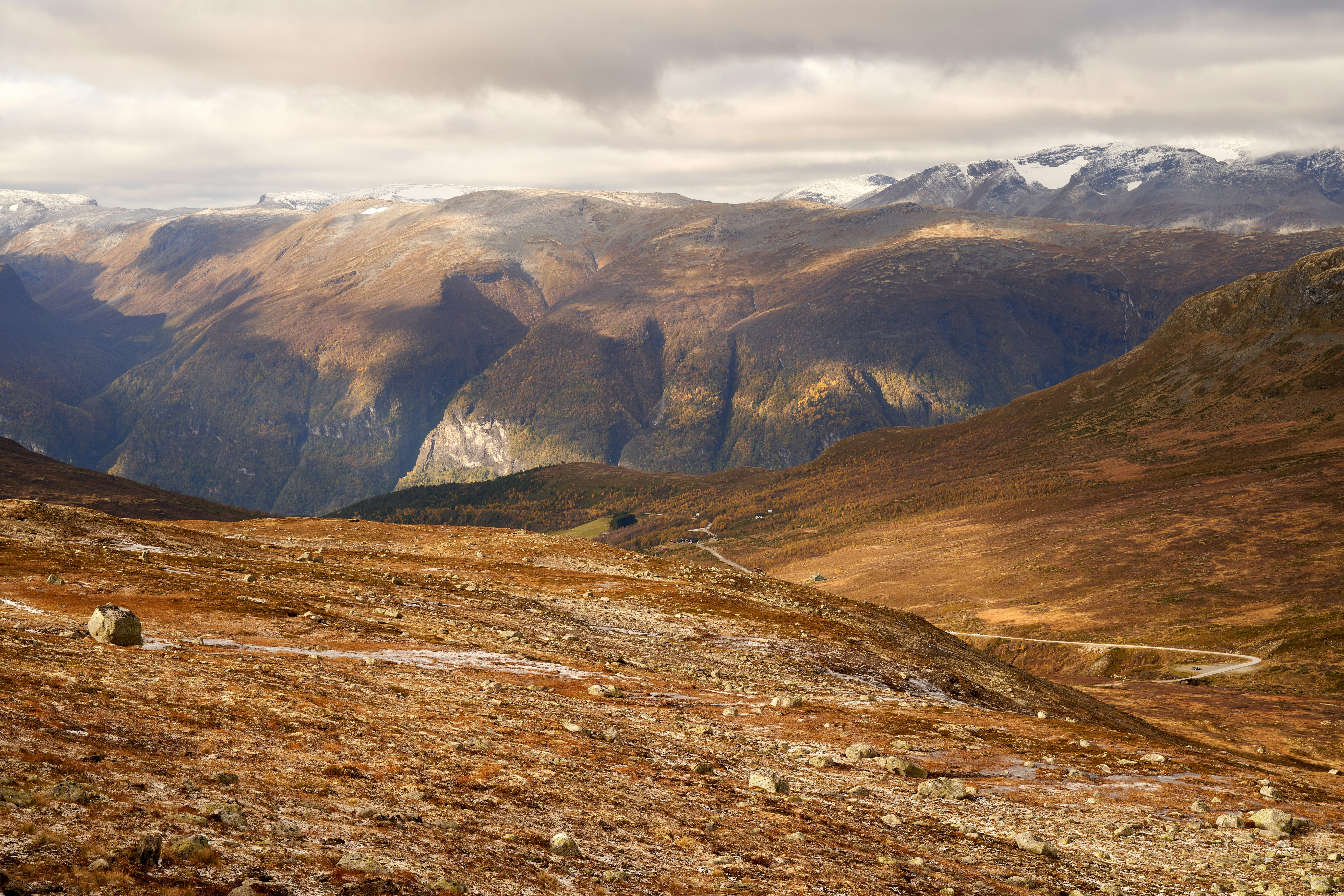 a view of a mountain range with snow capped mountains in the distance, Aurland Highland: Harsh Beauty in Late Autumn