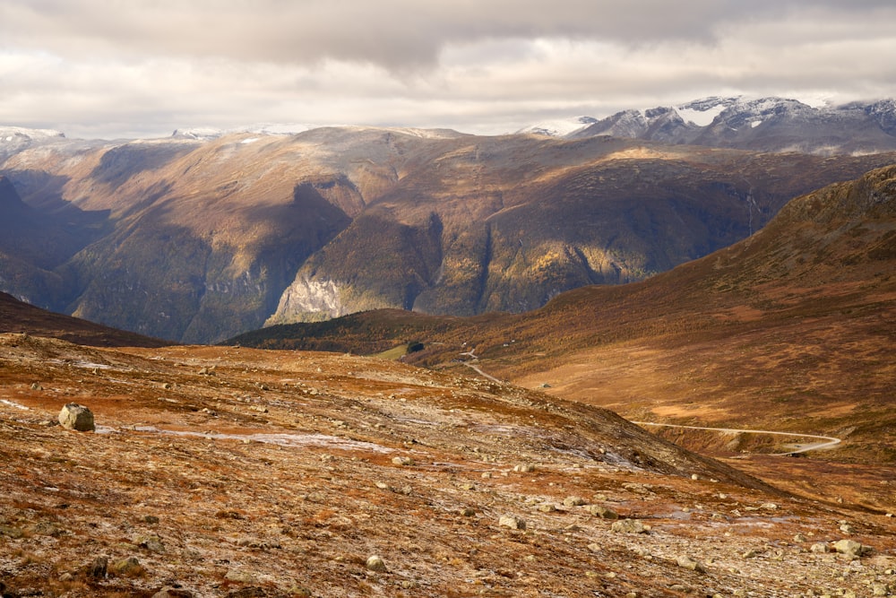 a view of a mountain range with snow capped mountains in the distance