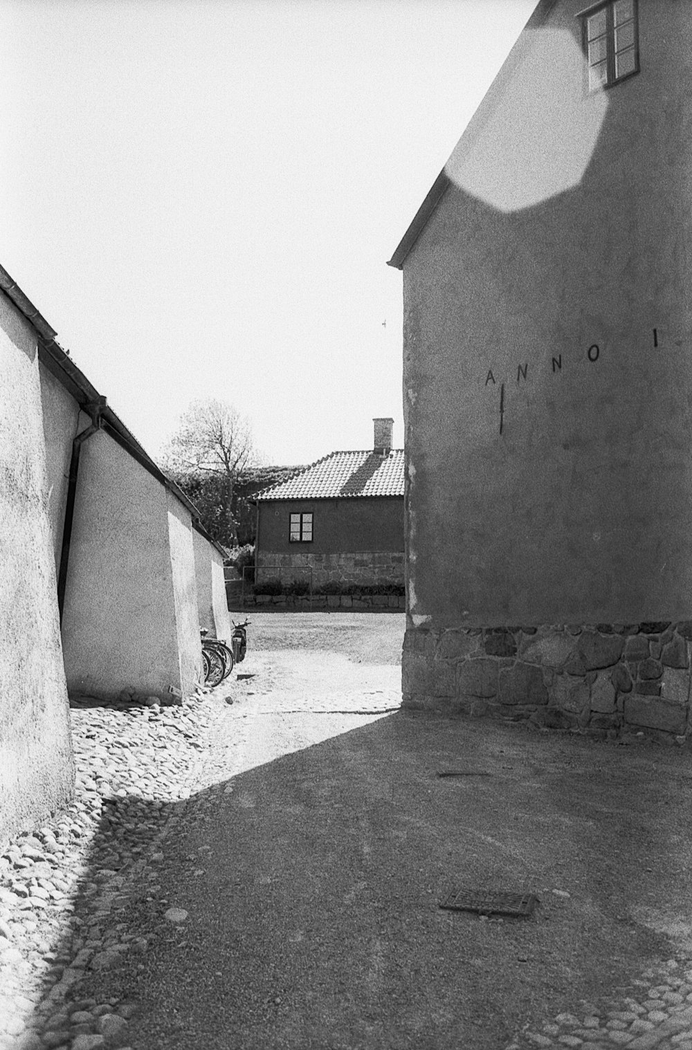 a black and white photo of an alley way