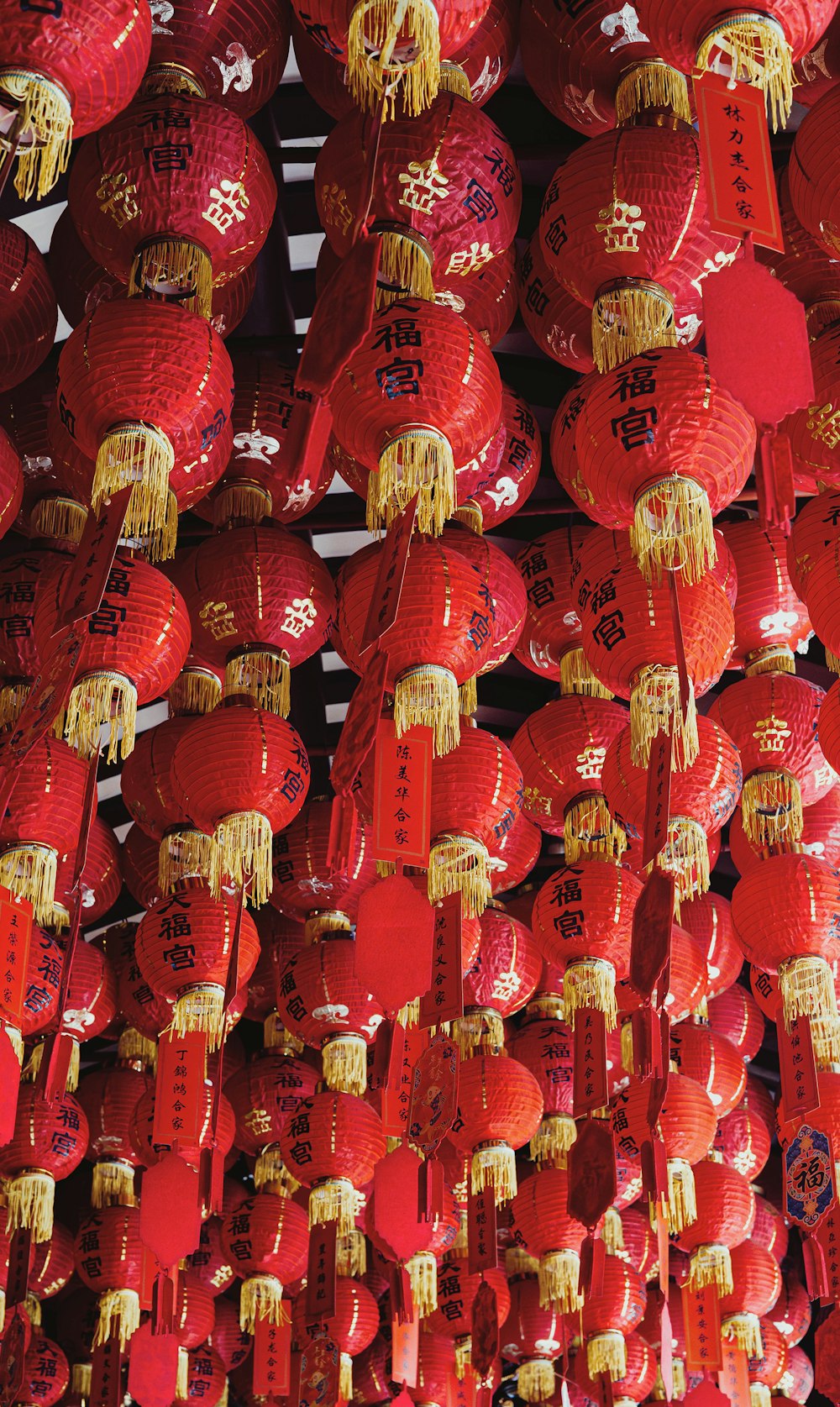 a bunch of red lanterns hanging from a ceiling