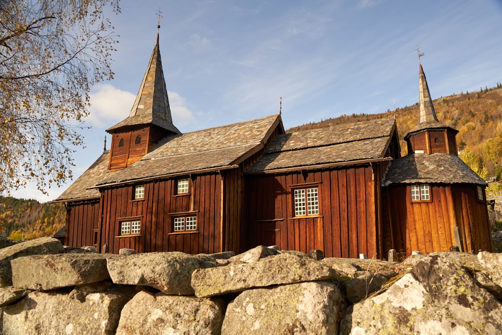 a wooden church with two steeples on top of it