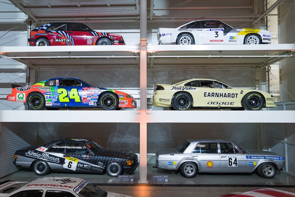 a group of cars sitting on top of a shelf