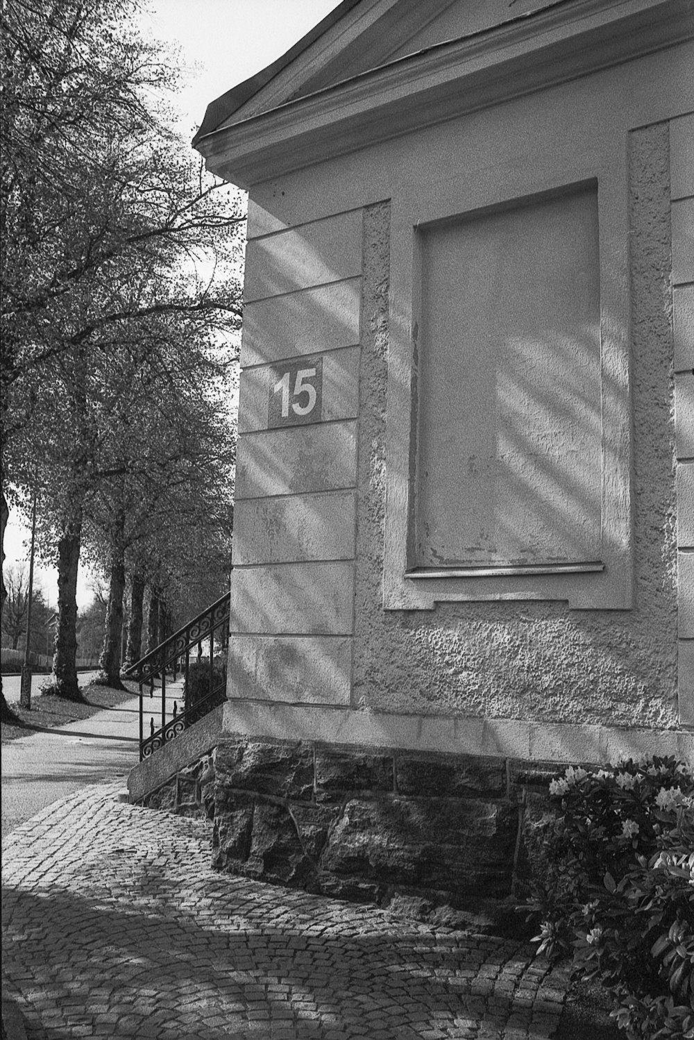 a black and white photo of a building with a number on it