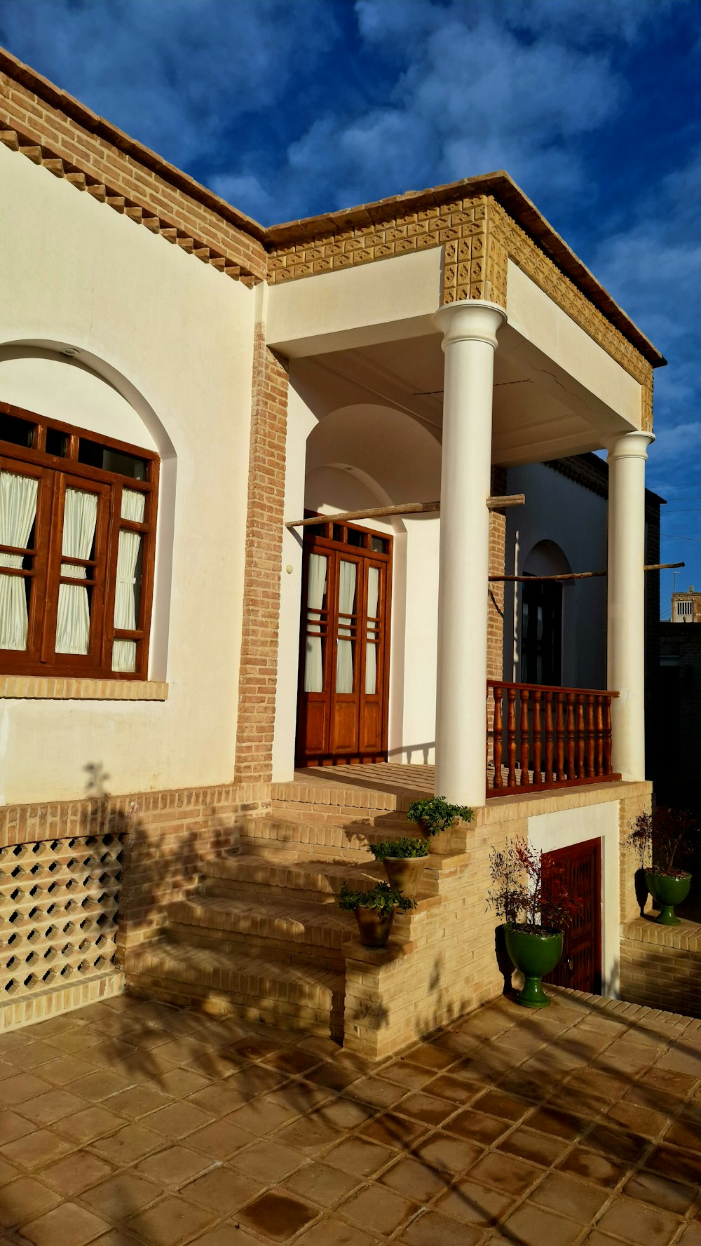 a white house with a red door and brown shutters