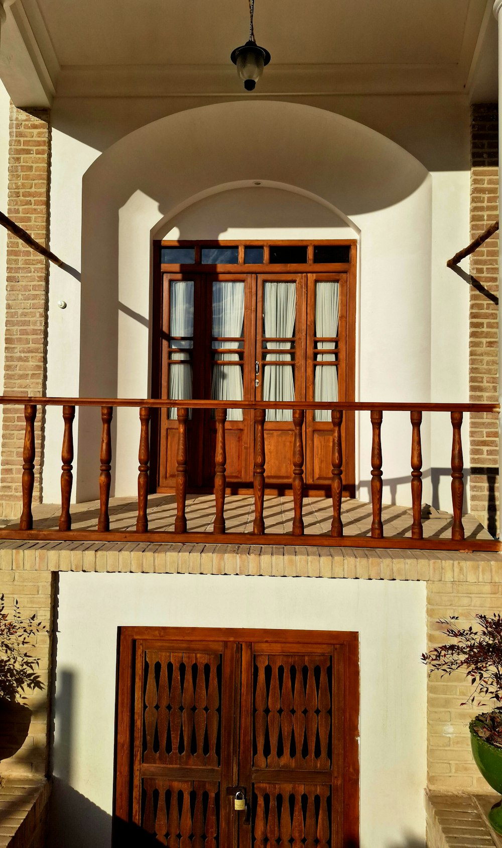 a balcony with two doors and a balcony railing