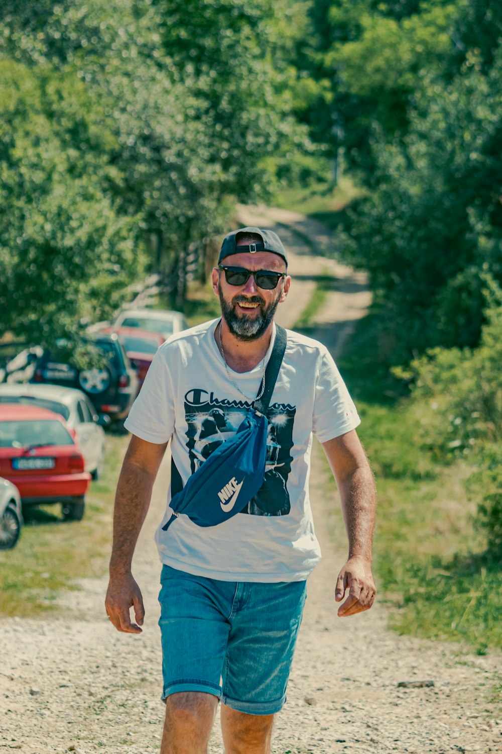 a man riding a skateboard down a dirt road