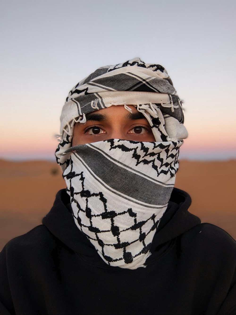 a man wearing a scarf over his face