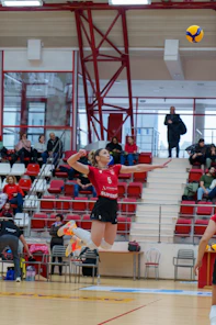 a woman jumping in the air to catch a ball