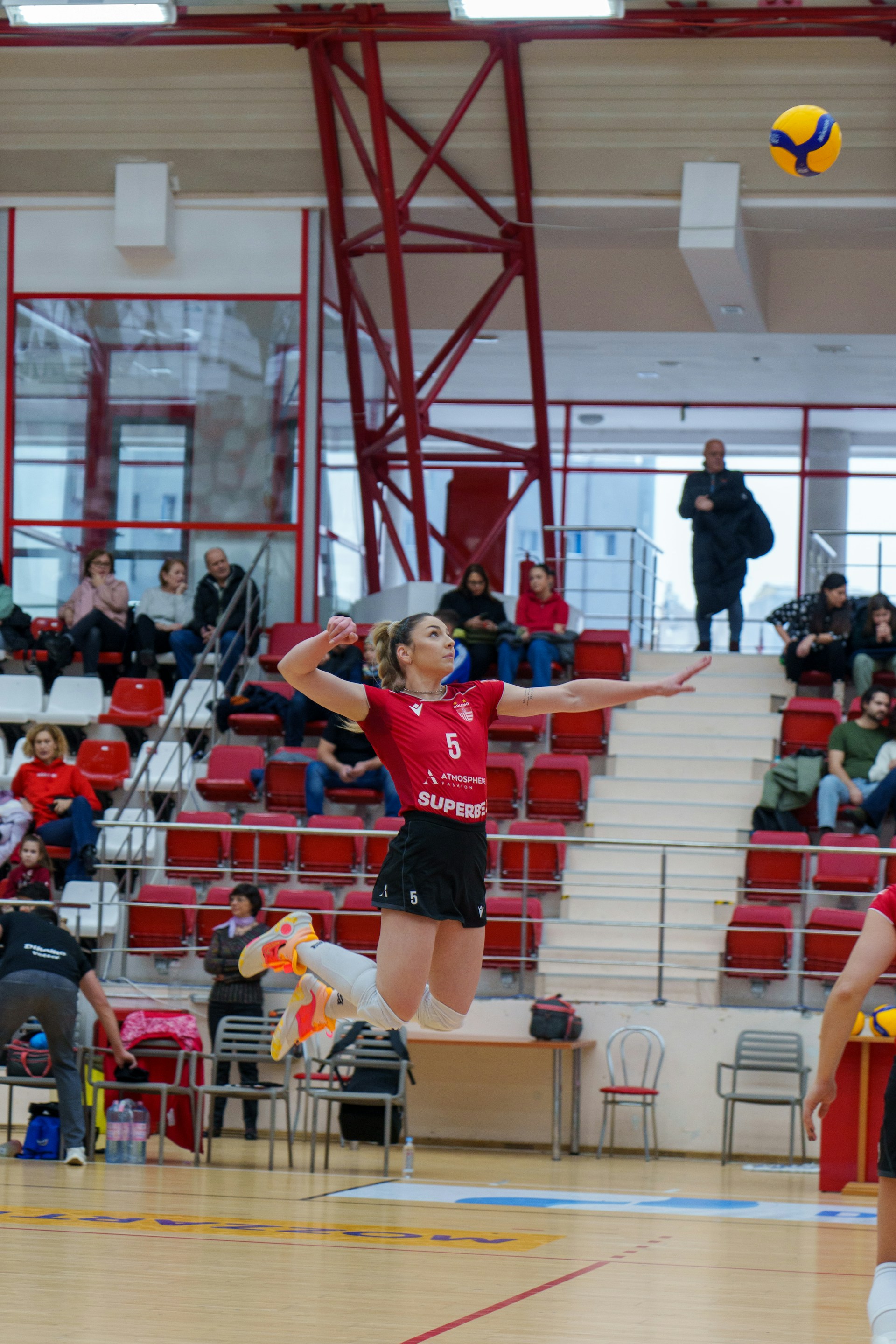 a woman jumping in the air to catch a ball