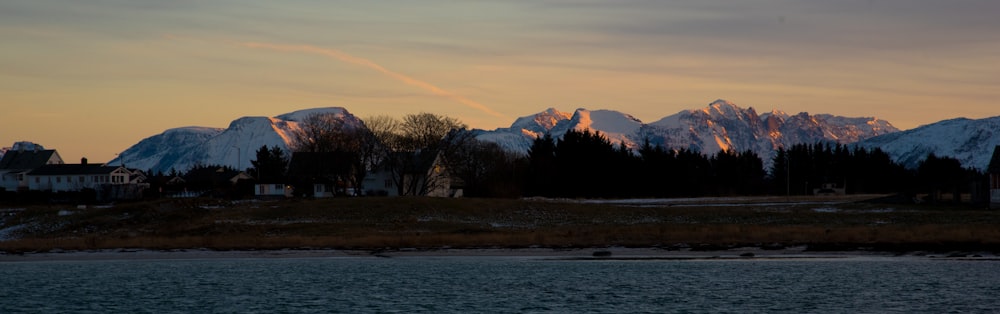 a view of a mountain range with a lake in the foreground