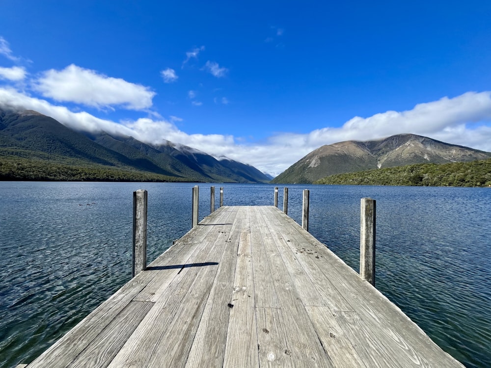 a wooden dock sitting on top of a lake