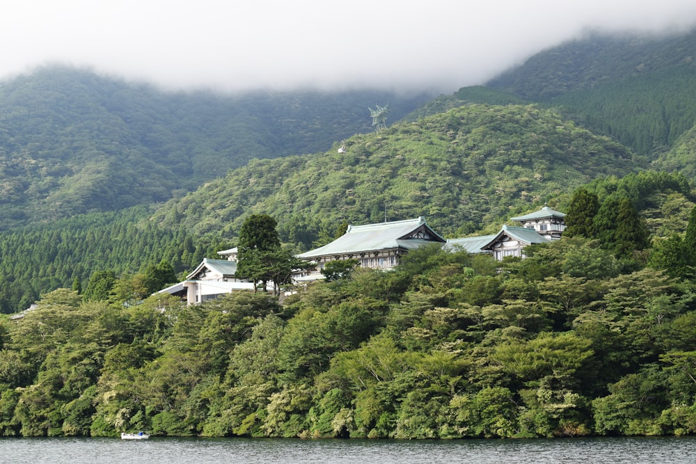 a house on the side of a mountain overlooking a body of water