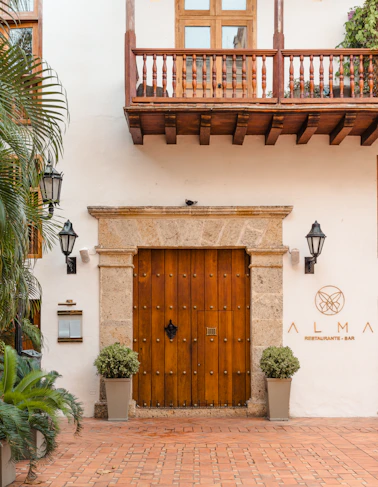 a large wooden door sitting next to a tall building
