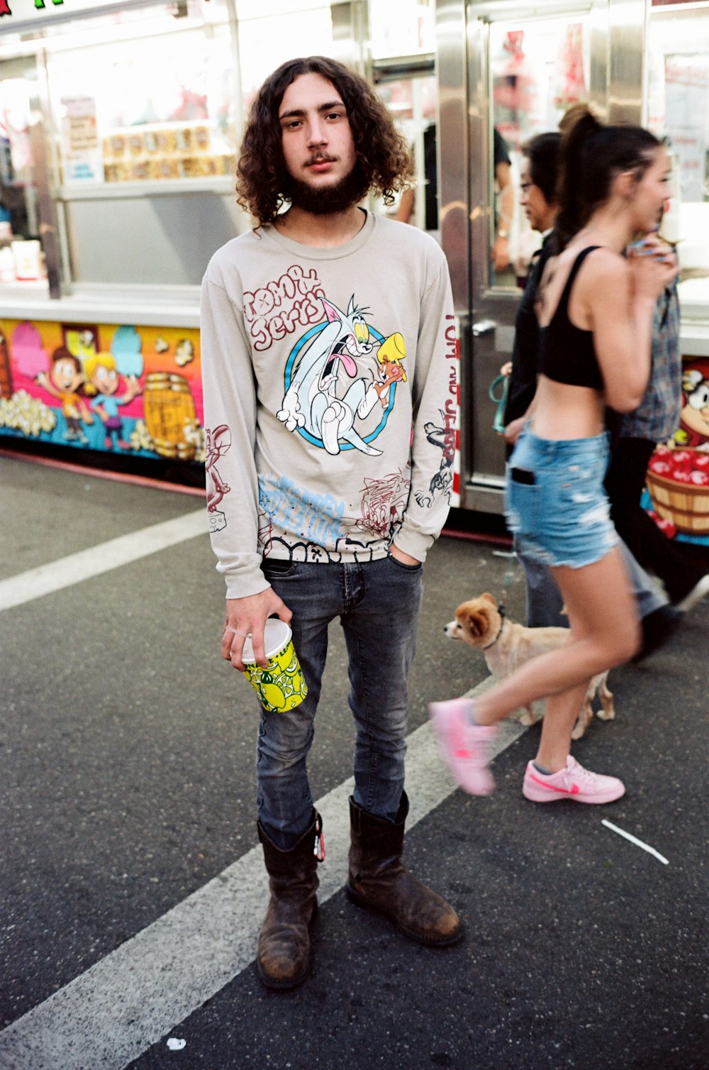 a man with a beard standing in front of a food truck