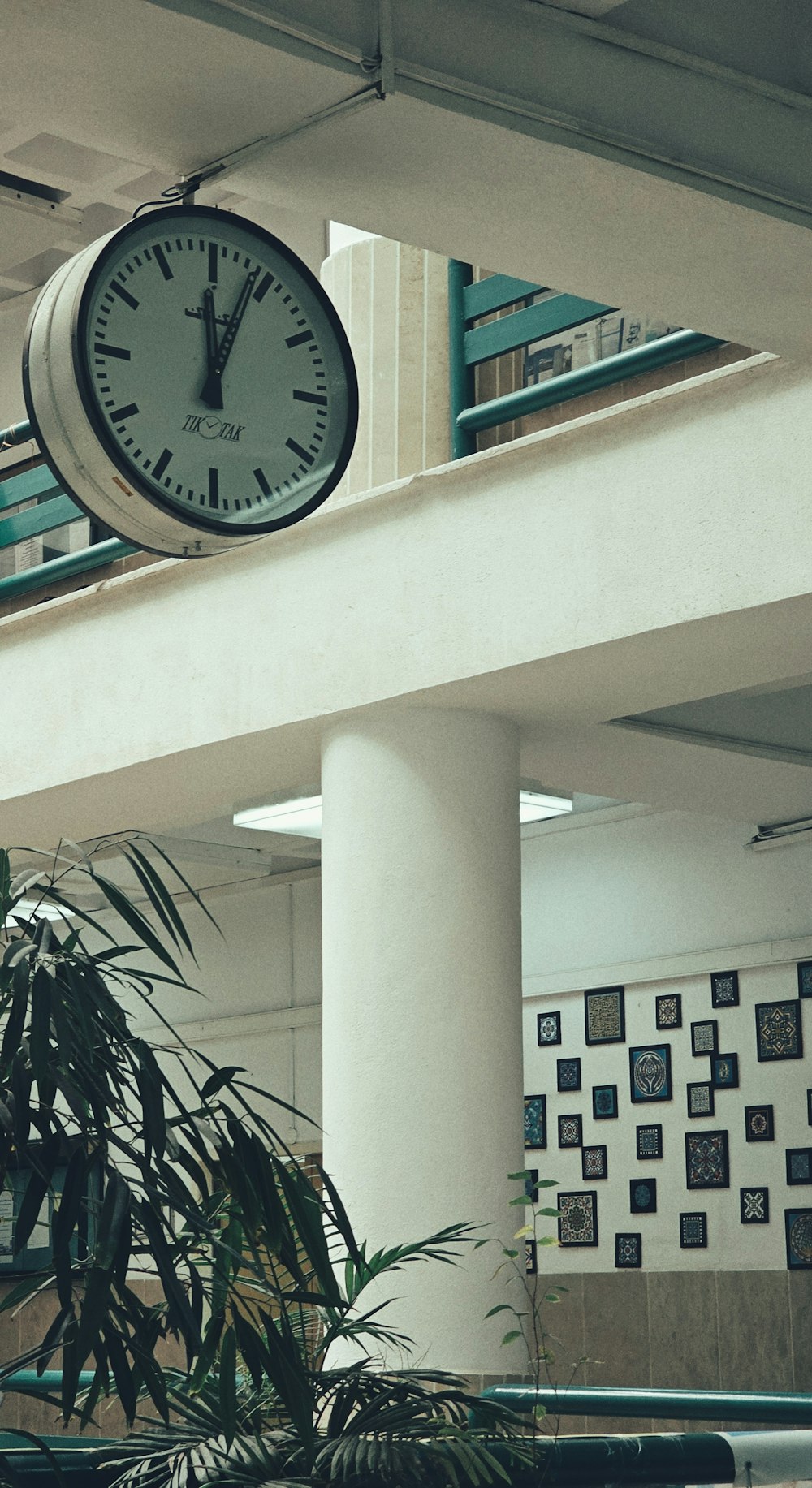 a clock hanging from the ceiling of a building