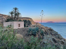 a house on a cliff overlooking the ocean