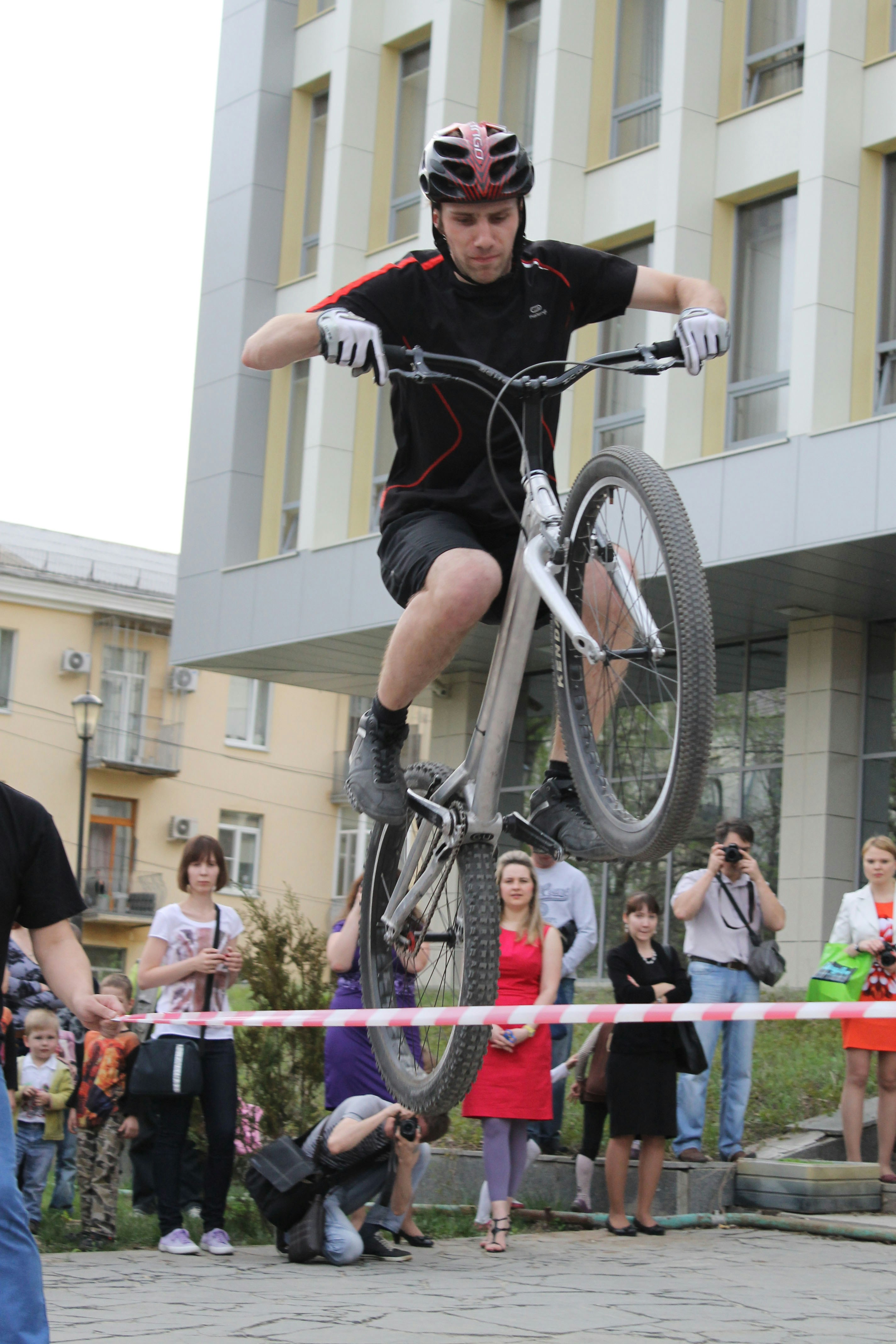 a man on a bicycle jumping over a barrier