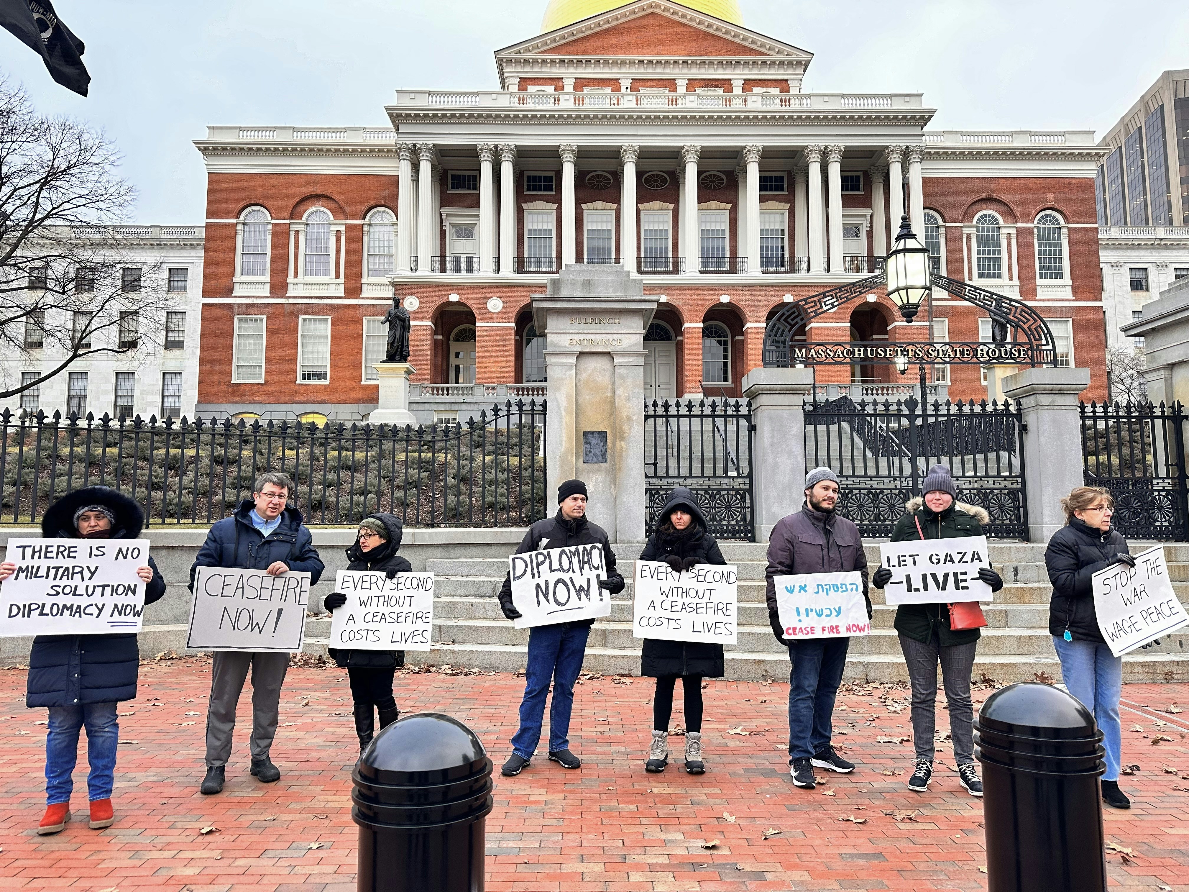 A group of people holding signs in front of a building