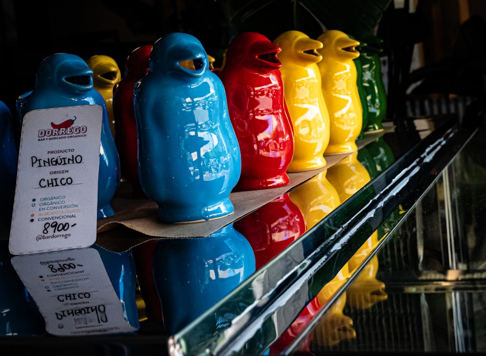 a row of colorful plastic bottles sitting on top of a shelf