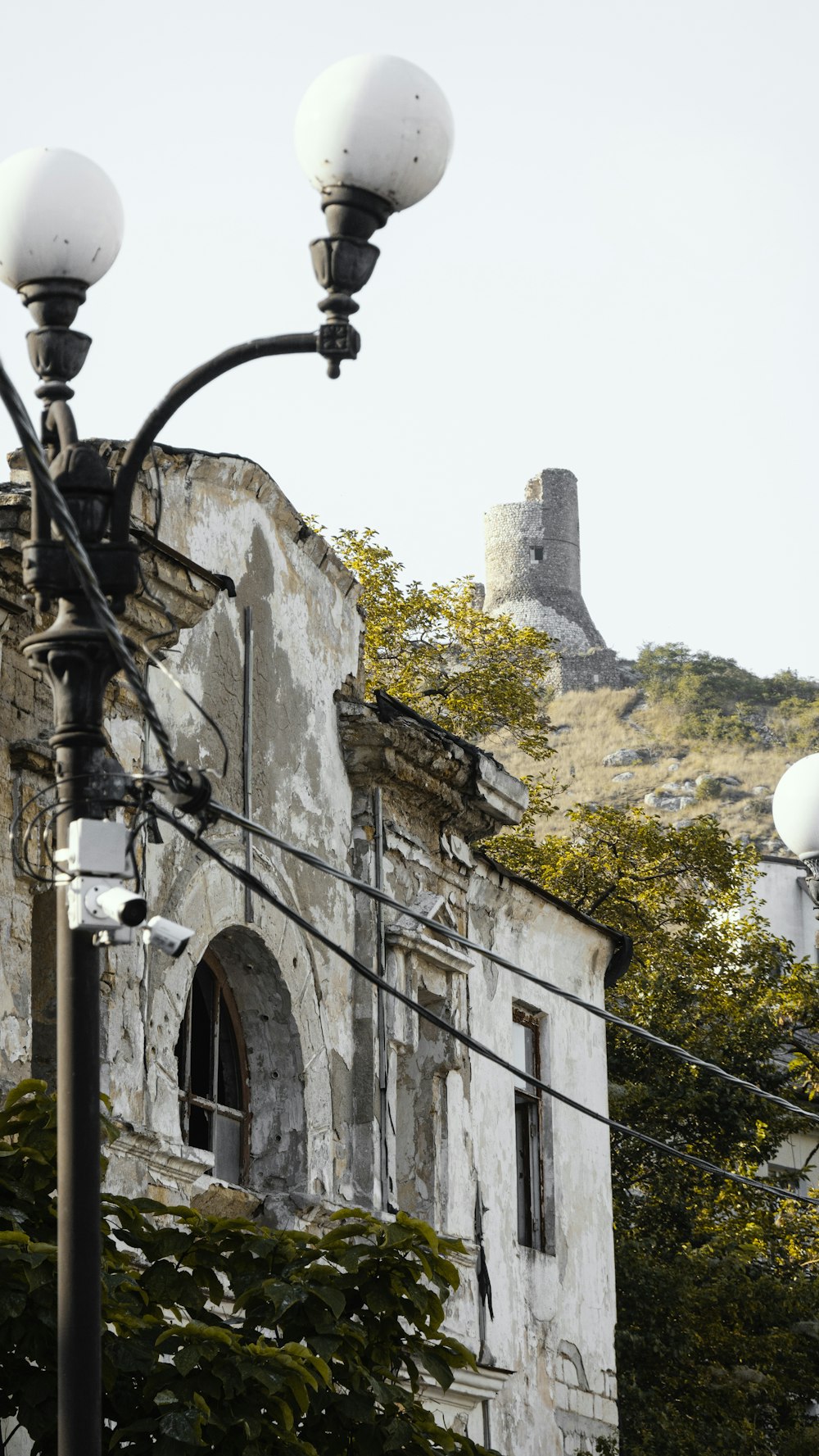 a street light with a building in the background