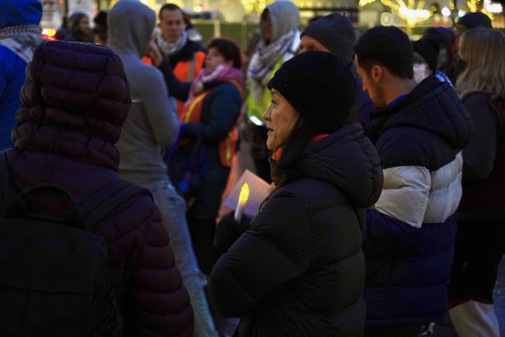 a crowd of people standing around each other