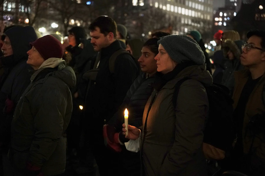 People holding candles at a night vigil