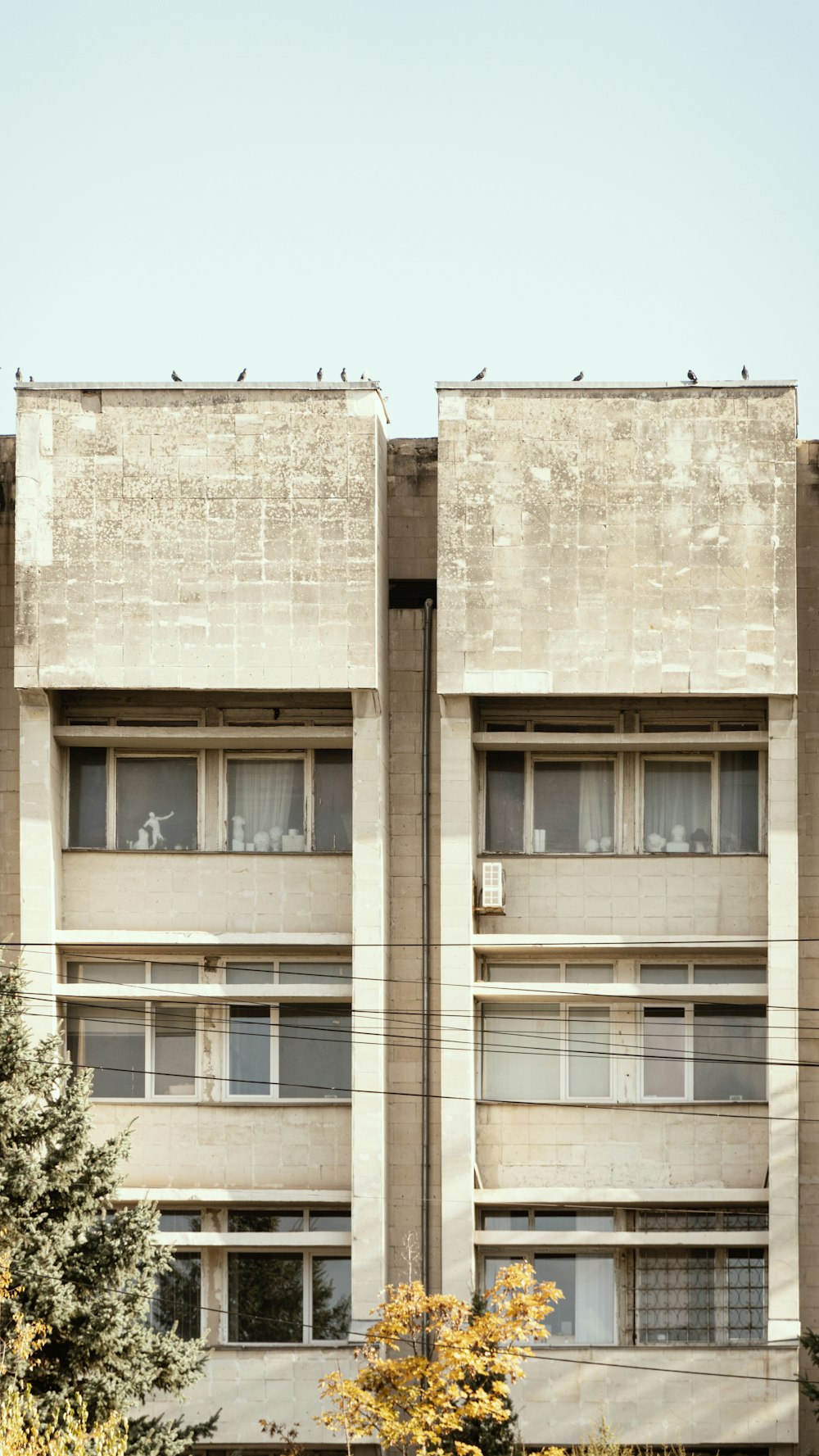 a tall building with windows and a clock on the side of it