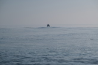 a small boat in the middle of the ocean
