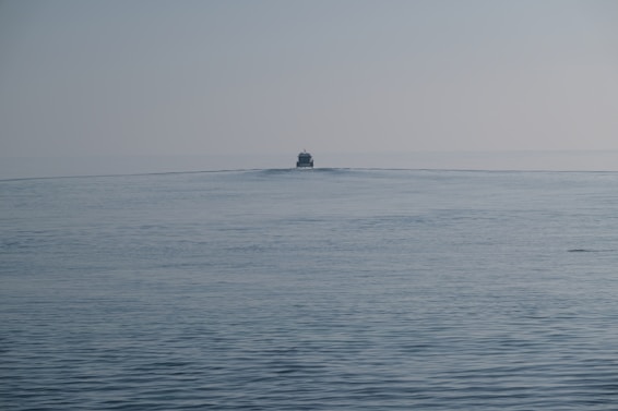 a small boat in the middle of the ocean