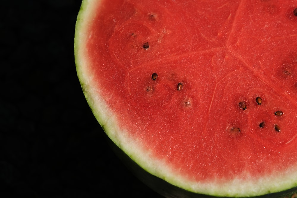 a slice of watermelon is shown on a black background