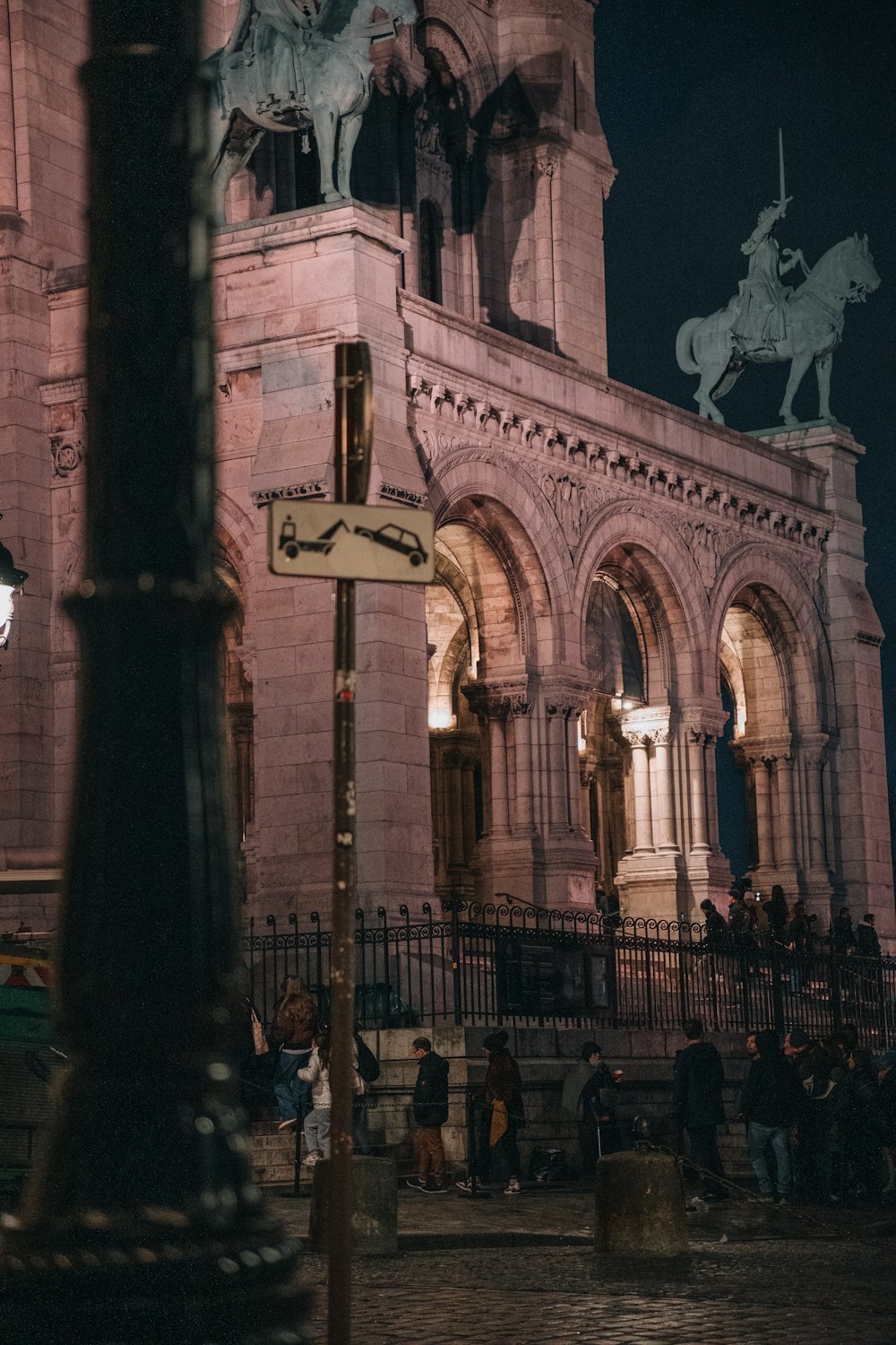 a tall building with a clock tower and a statue of a man on a horse