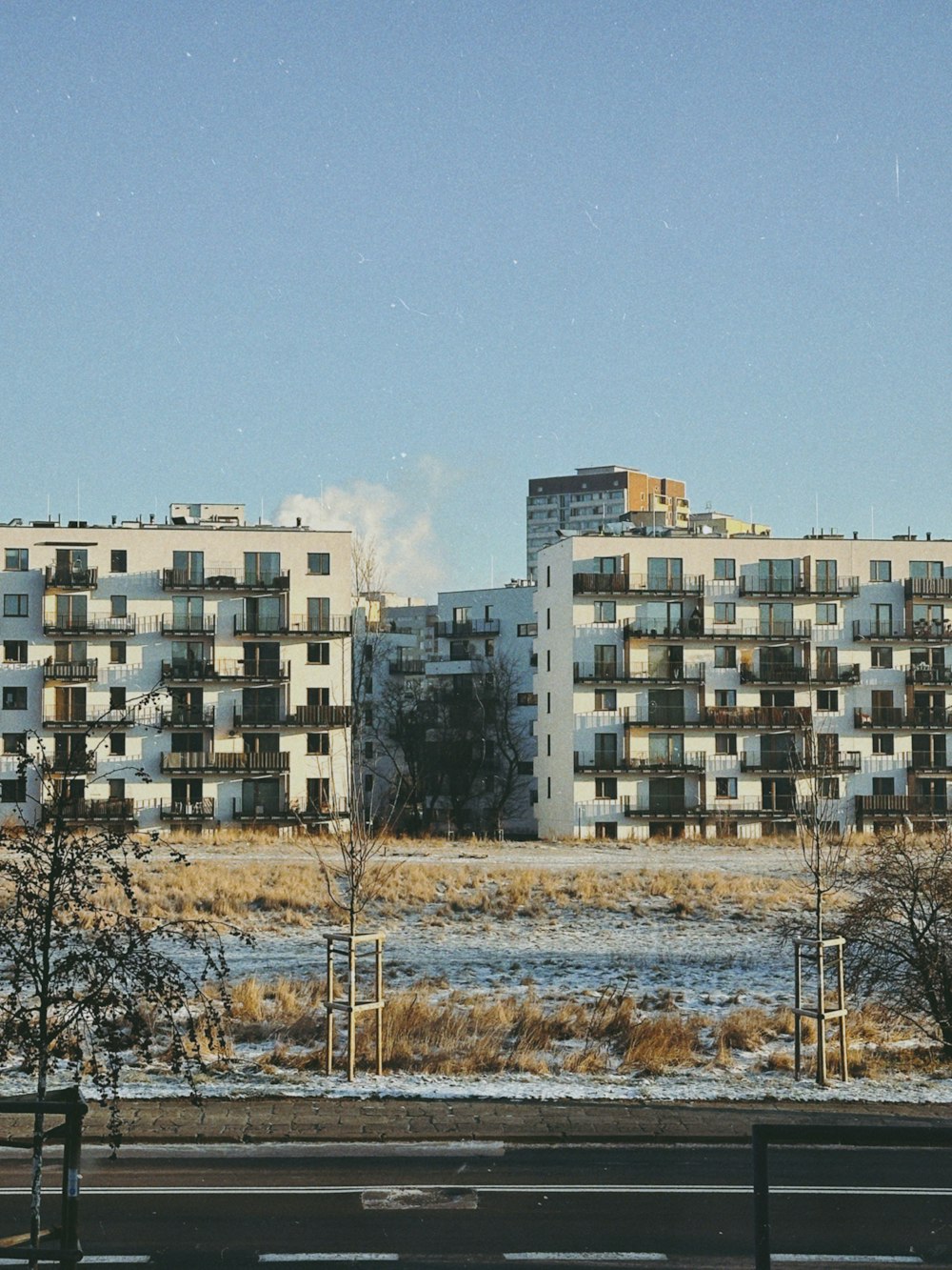 a large apartment building sitting on the side of a road