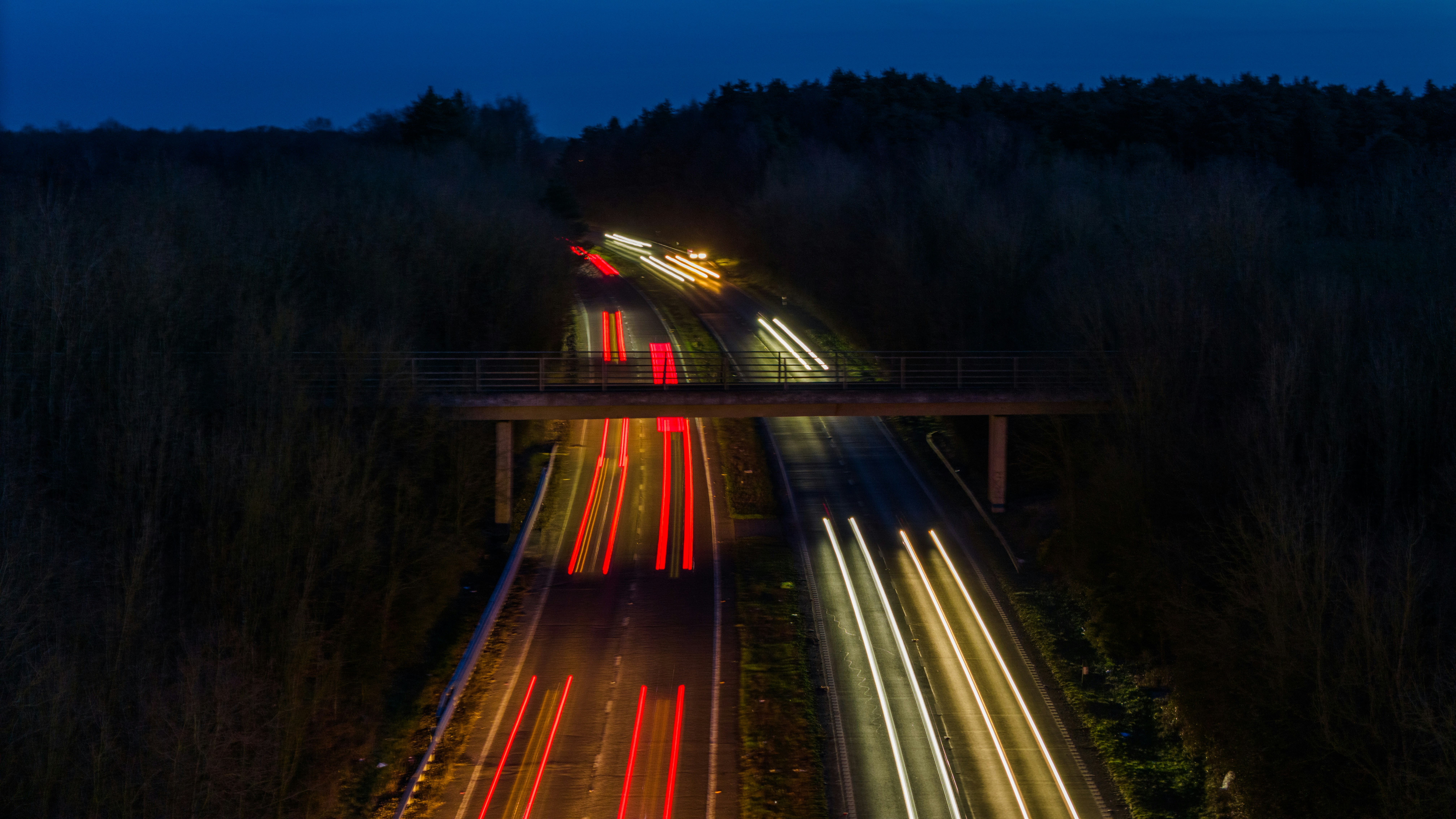 a long exposure photo of a highway at night