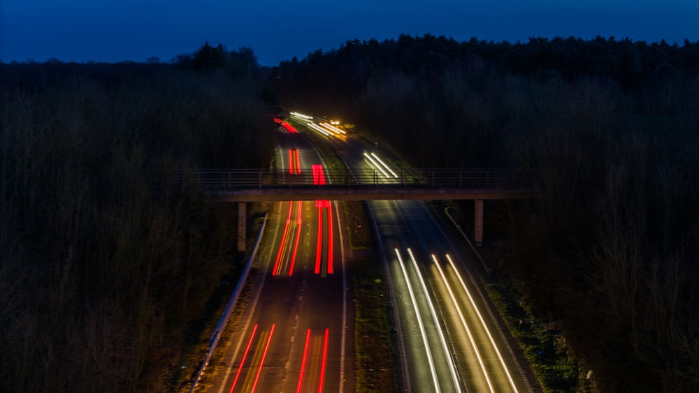 a long exposure photo of a highway at night