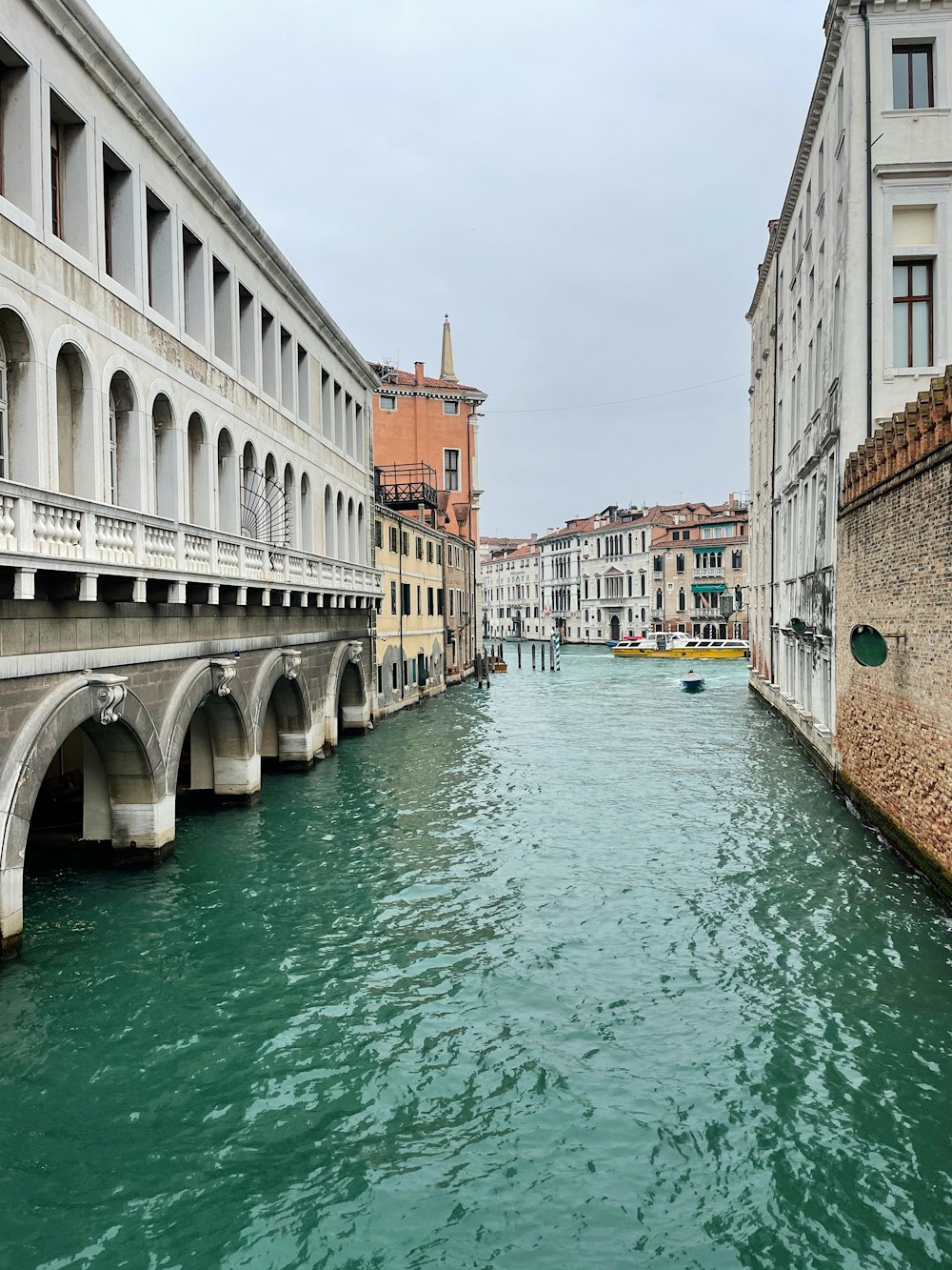 a river running through a city next to tall buildings