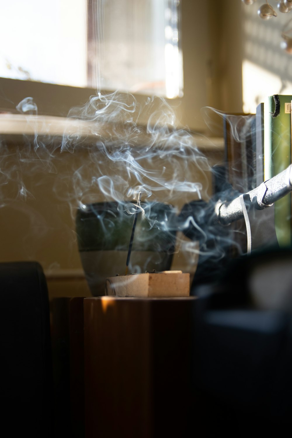 smoke coming out of a coffee cup on a table