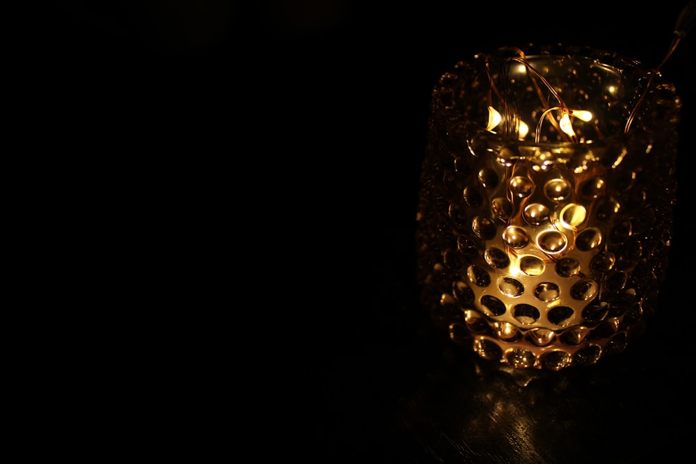 a candle that is lit up in the dark