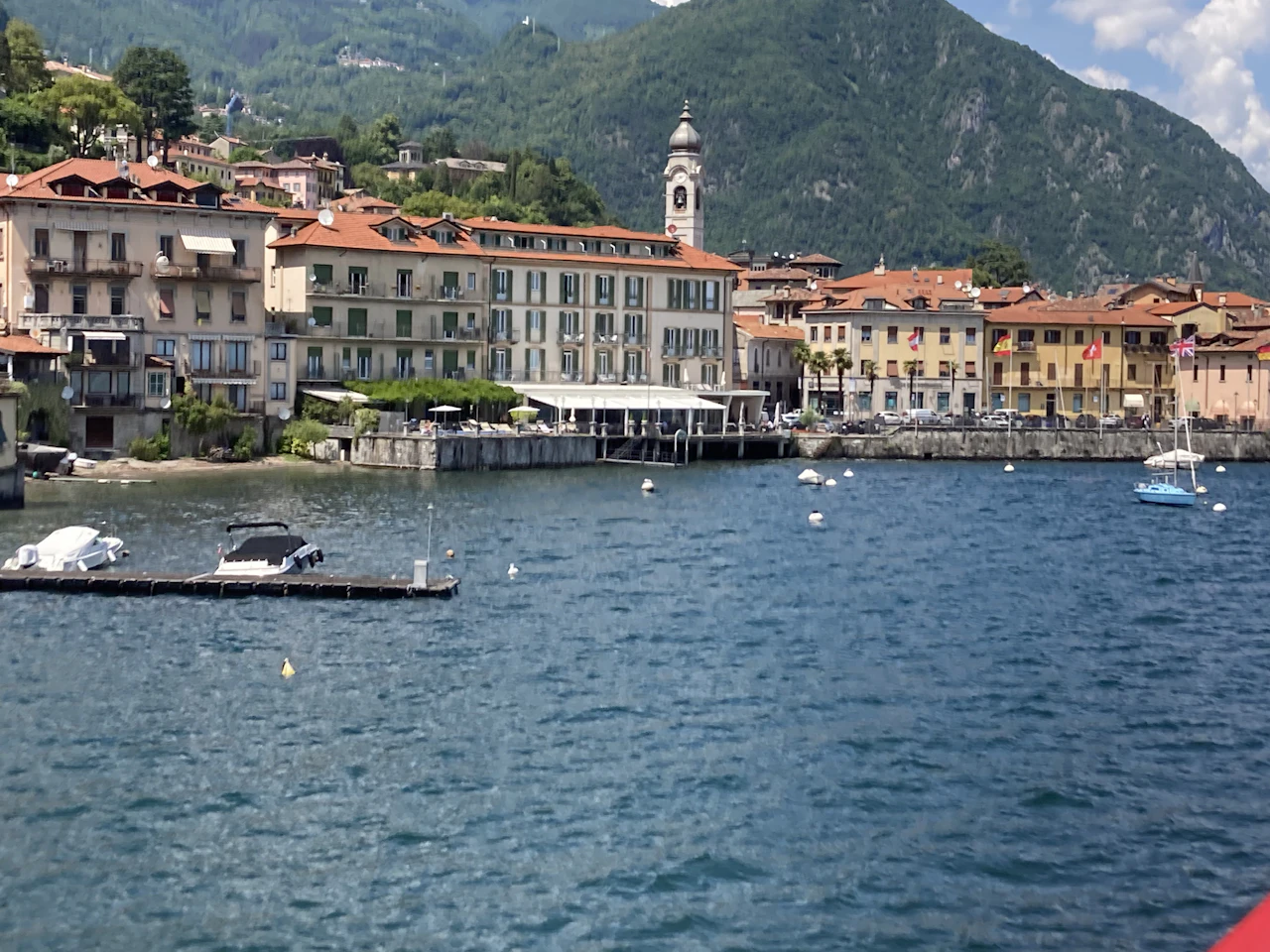 Boats gathered in a small harbour below the mountains