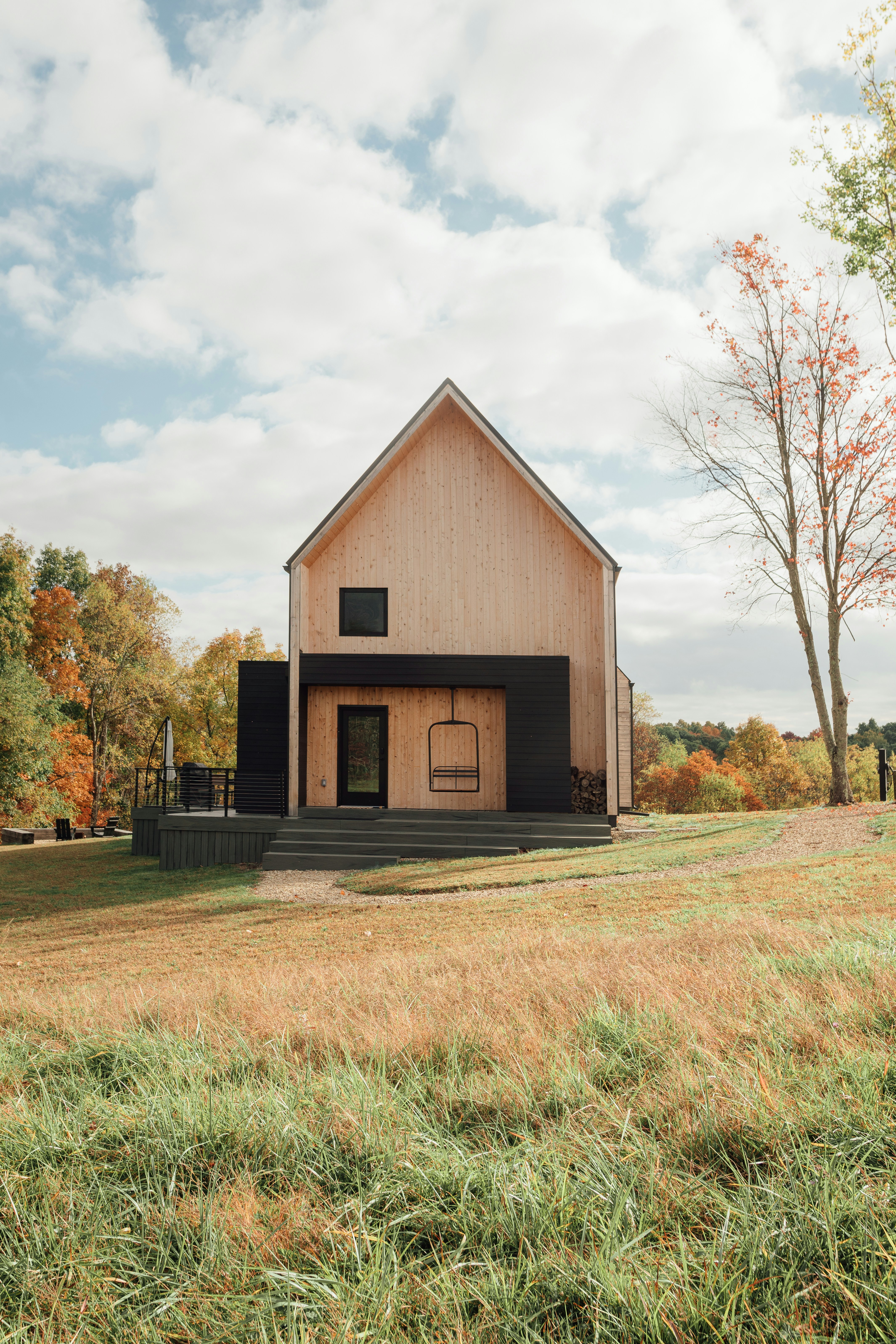a barn with a large open door in a field