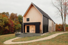 a black and white house with stairs leading up to it