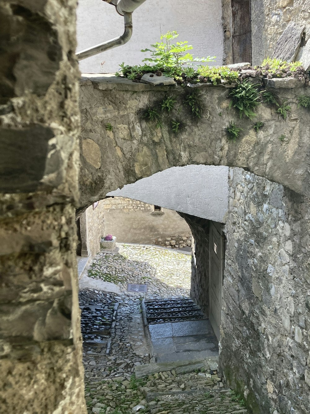 a stone building with a stone walkway going through it