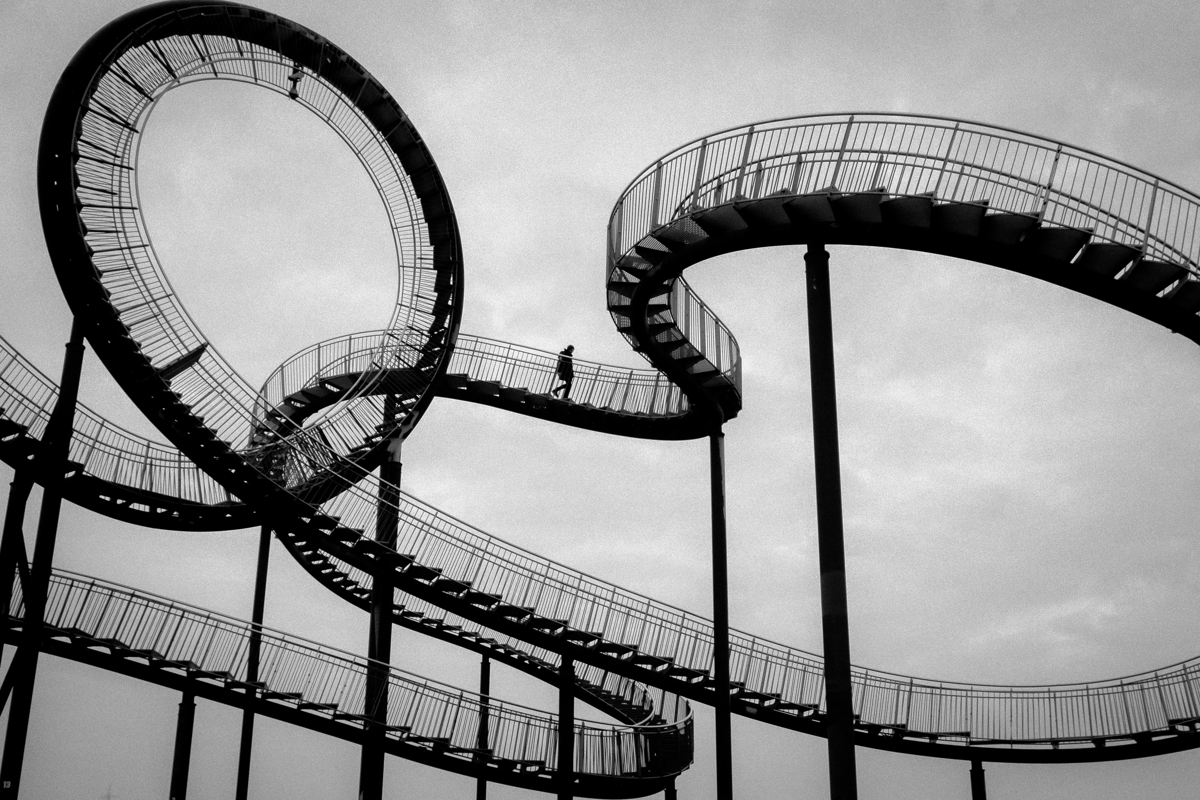 a black and white photo of a roller coaster