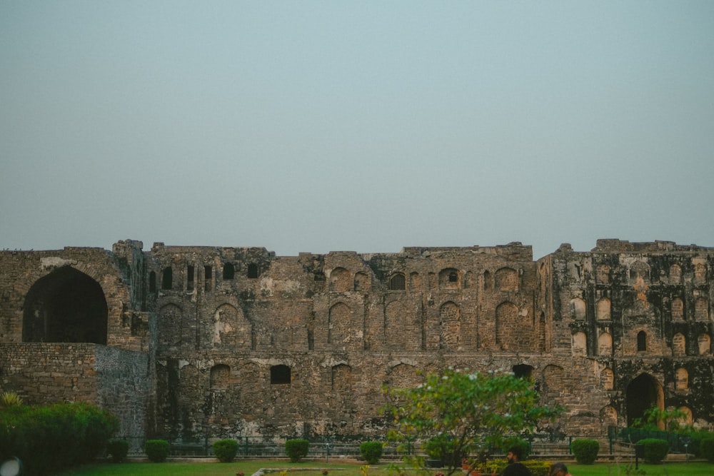 a stone building with a green lawn in front of it