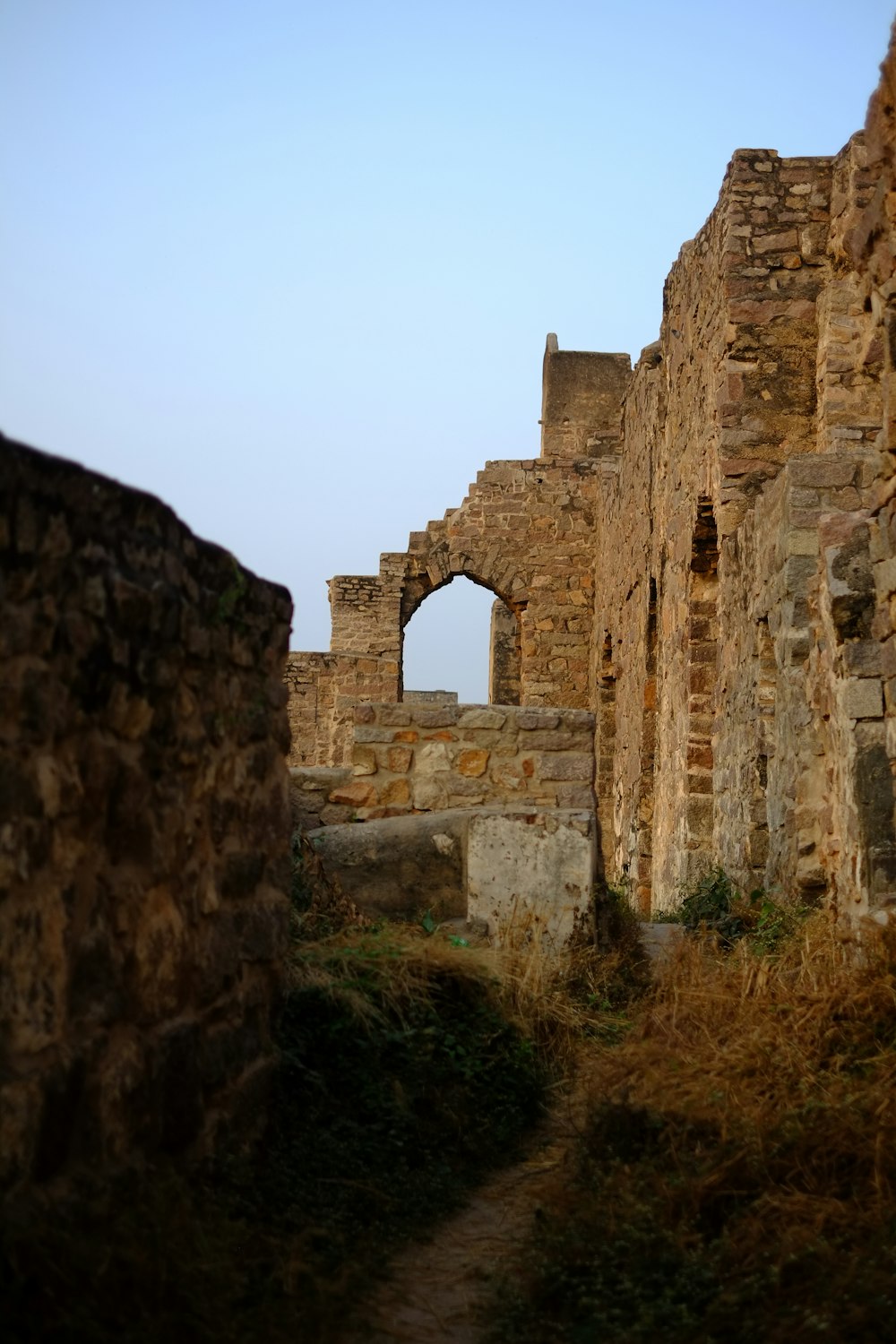 an old stone building with a stone arch in the middle of it