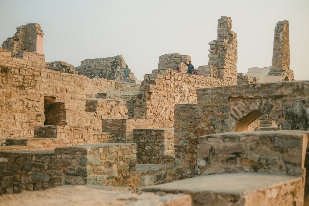 a man standing on a stone structure in a city