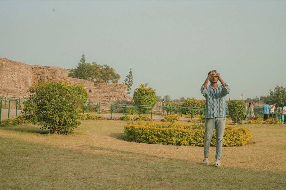 a man taking a picture of himself in a park