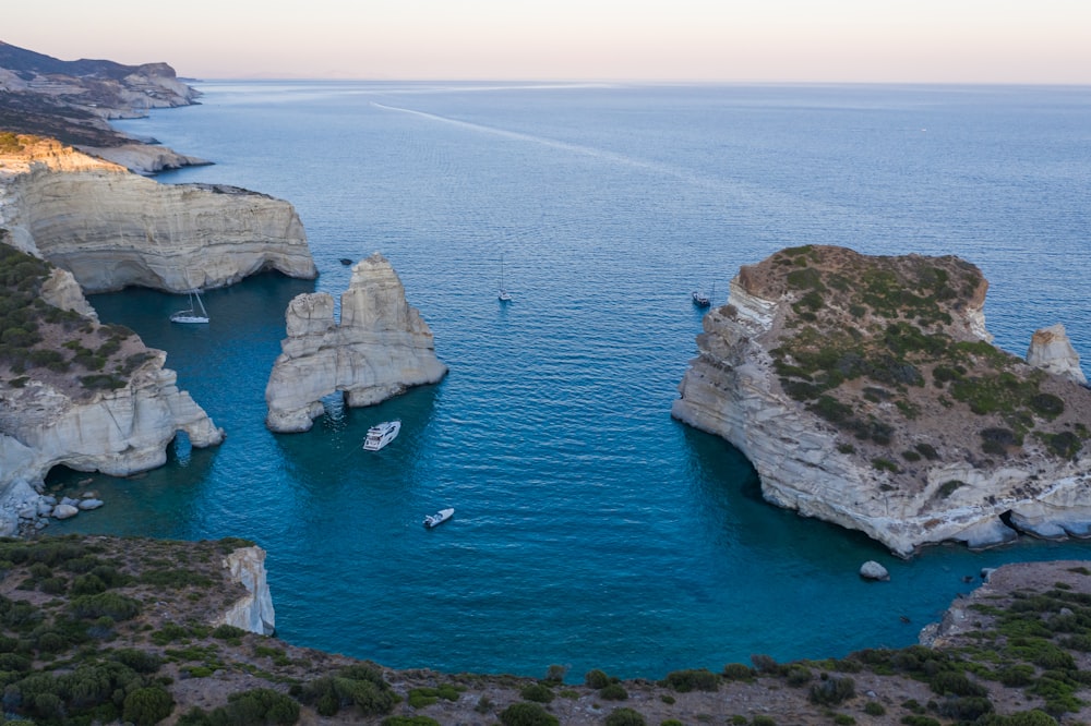 a group of boats floating on top of a body of water