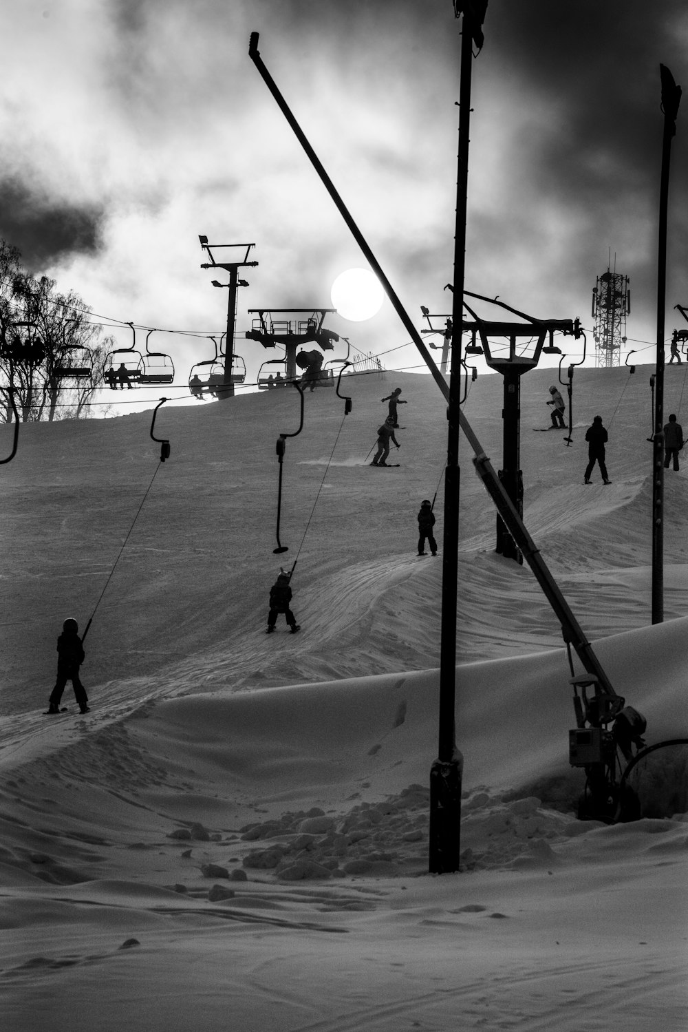 a group of people riding skis down a snow covered slope